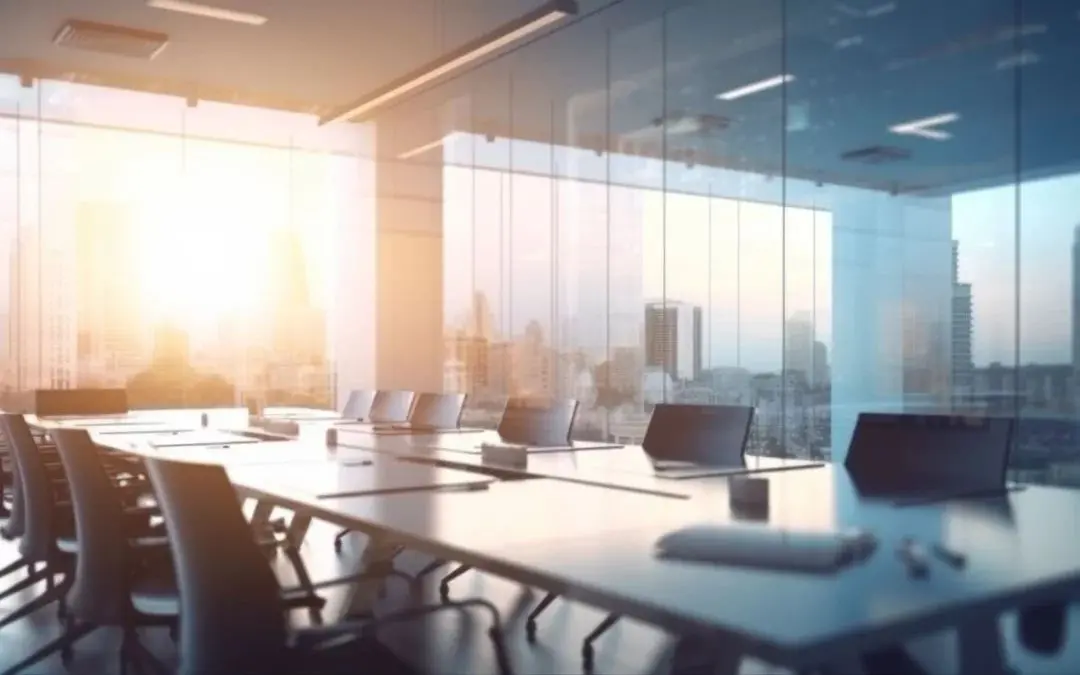 A conference room with tables and chairs, a window and a view of the city.