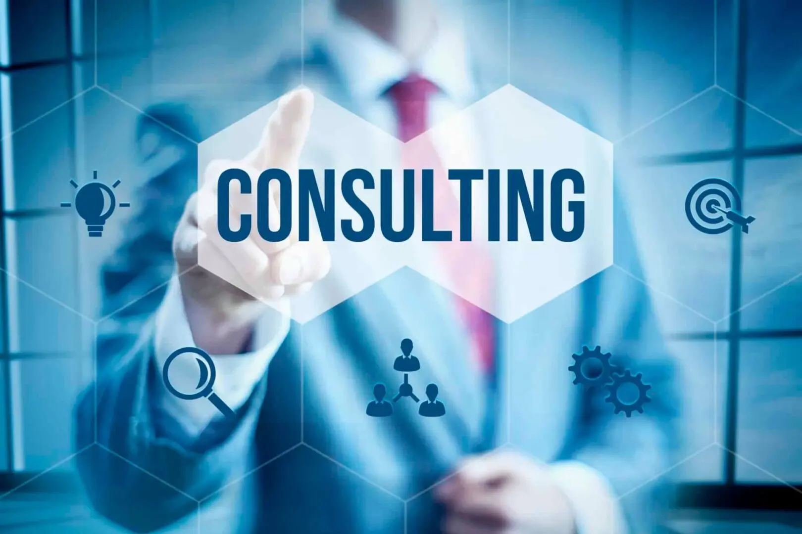 A man in a suit and tie pointing to the word consulting.